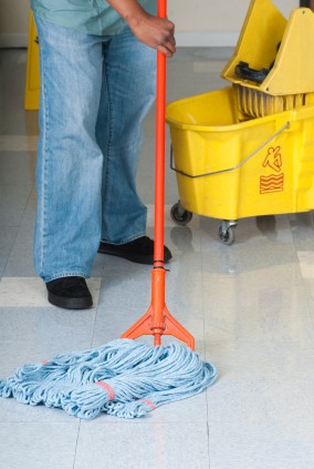 Cleanup Man janitor in Burrel, CA mopping floor.